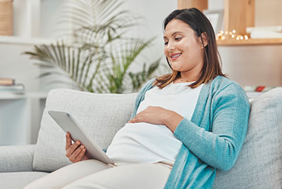 pregnant Hispanic woman looking at families to adopt her baby