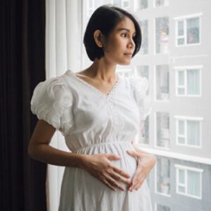 A pregnant Hispanic woman with common adoption questions considering adoption for her baby