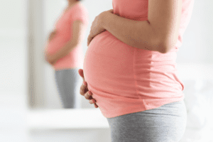 Pregnant Hispanic woman's belly